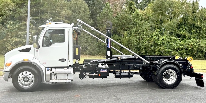 HOOKLIFT TRUCKS IN STOCK NOW! INSTALITIONS: PIONEER TARPS INSTALLED.